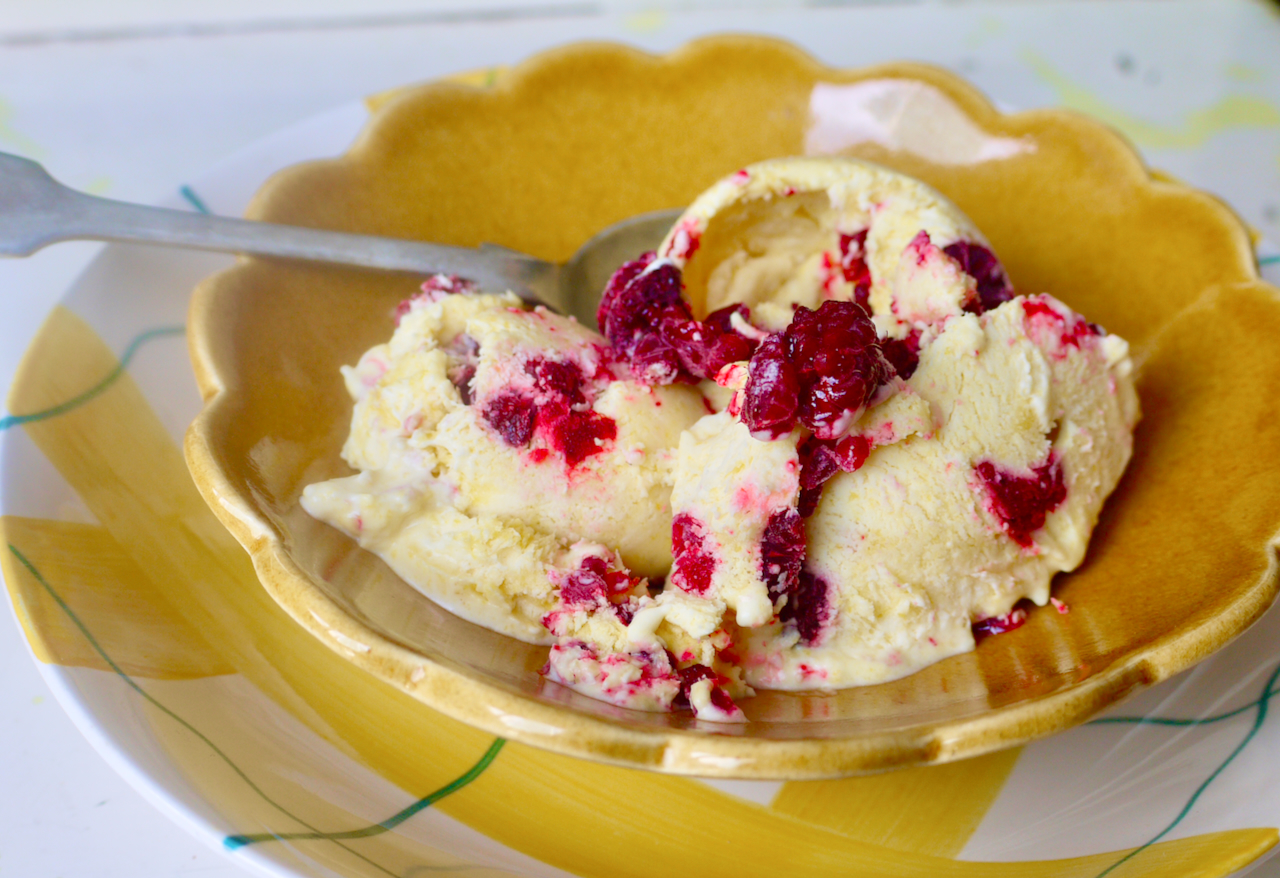 A close up of ice cream in a bowl, resting in another bowl