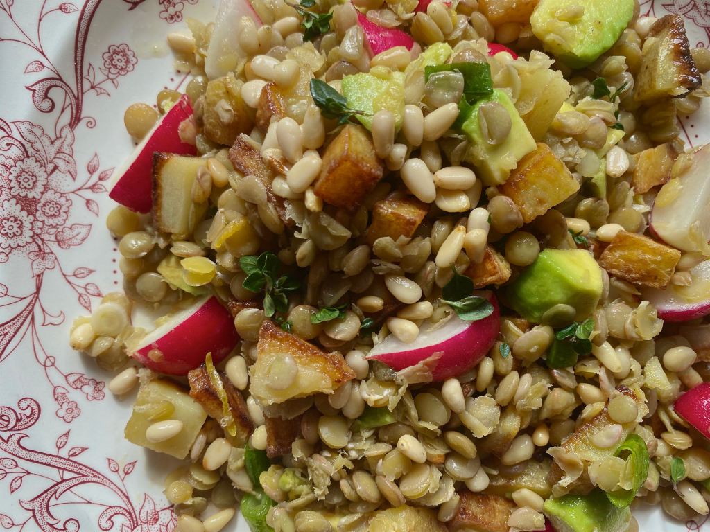A close up of the salad on a pink and white plate. This image links through to a web page with the recipe.