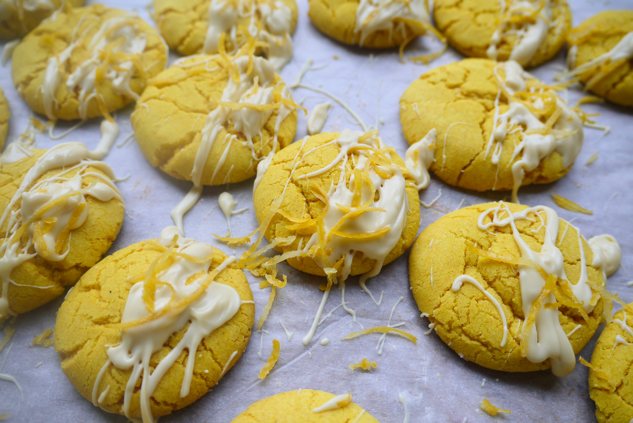 Lemon turmeric cookies with white chocolate drizzled on them