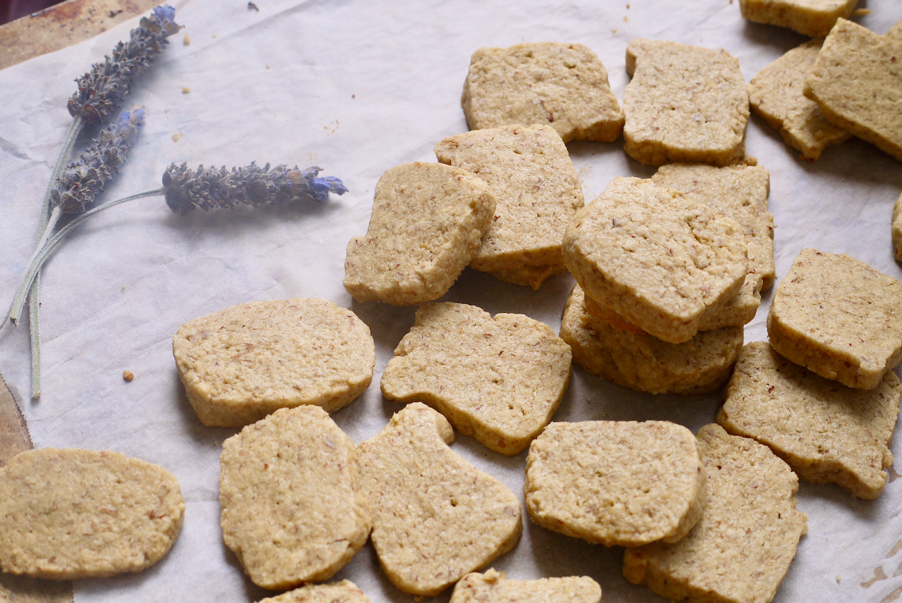 A stack of biscuits with a few sprigs of lavendar next to them