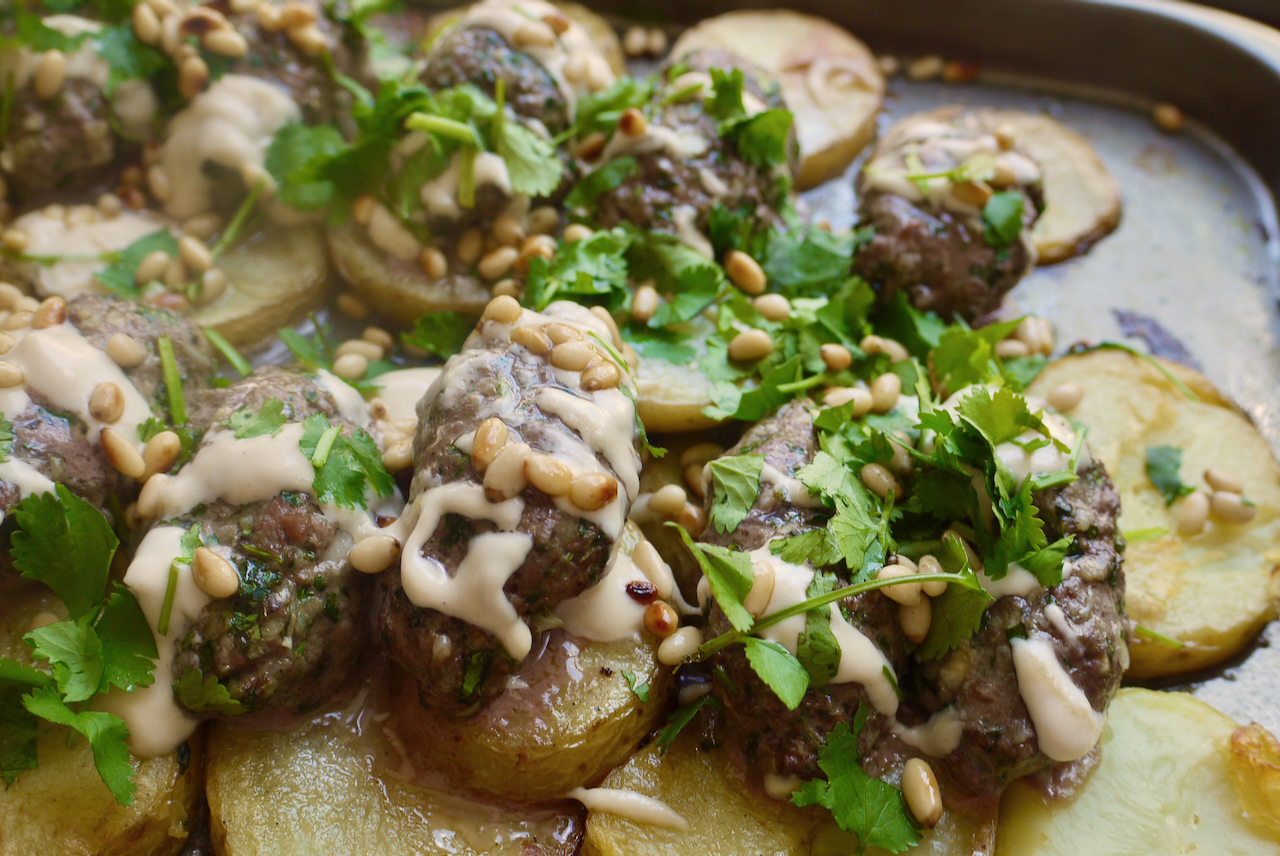 Close up of lamb kefte with coriander and pine nuts