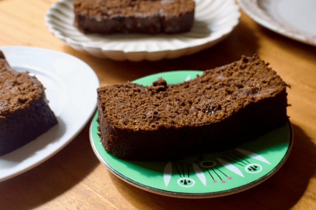 A slice of loaf cake on a green cake. This image links through to a web page with the recipe.