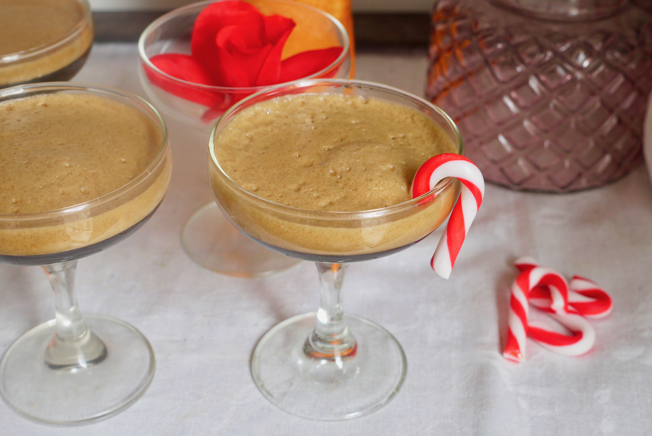 espresso martinis lined up with a candy cane on the rim of one glass