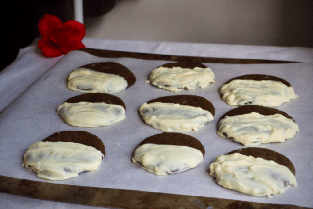 White chocolate-dipped cookies on a tray. This image links through to a web page with the recipe.