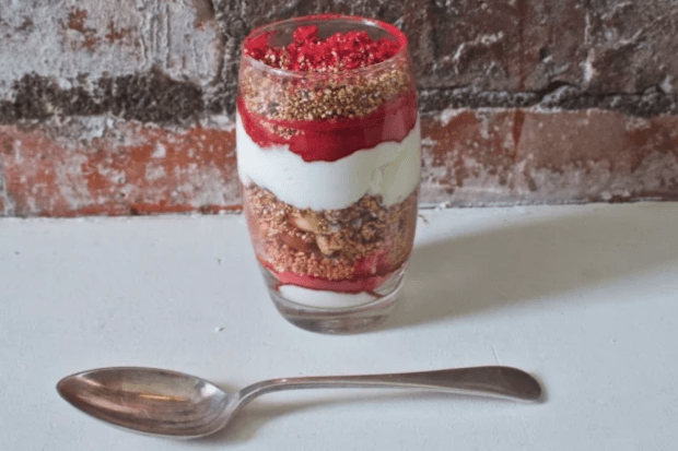 A glass of granola layered with fruit and yoghurt. This image links through to a web page with the recipe. 