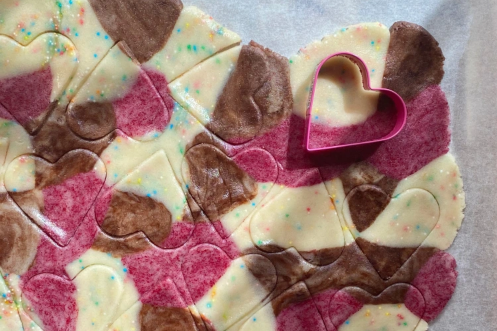 Rolled out multicoloured cookie dough. This image links through to a web page with the recipe.