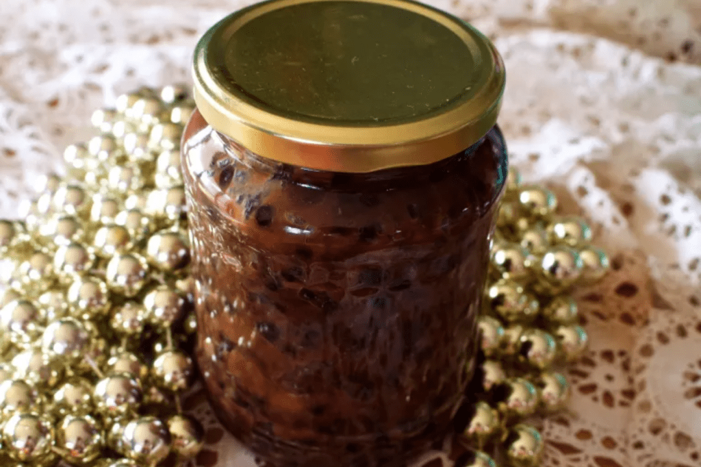 A jar of fruit mince surrounded by gold beads. This image links through to a web page with the recipe.
