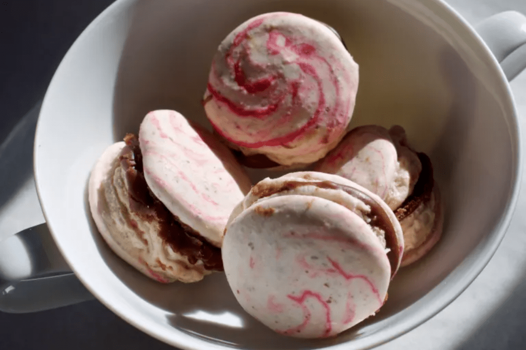 Several pink and white macarons. This image links through to a web page with the recipe.