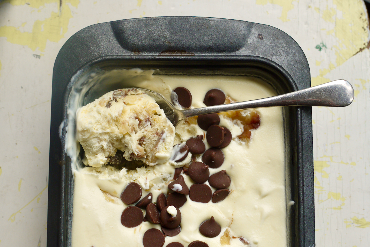 a spoonful of ice cream from a tin