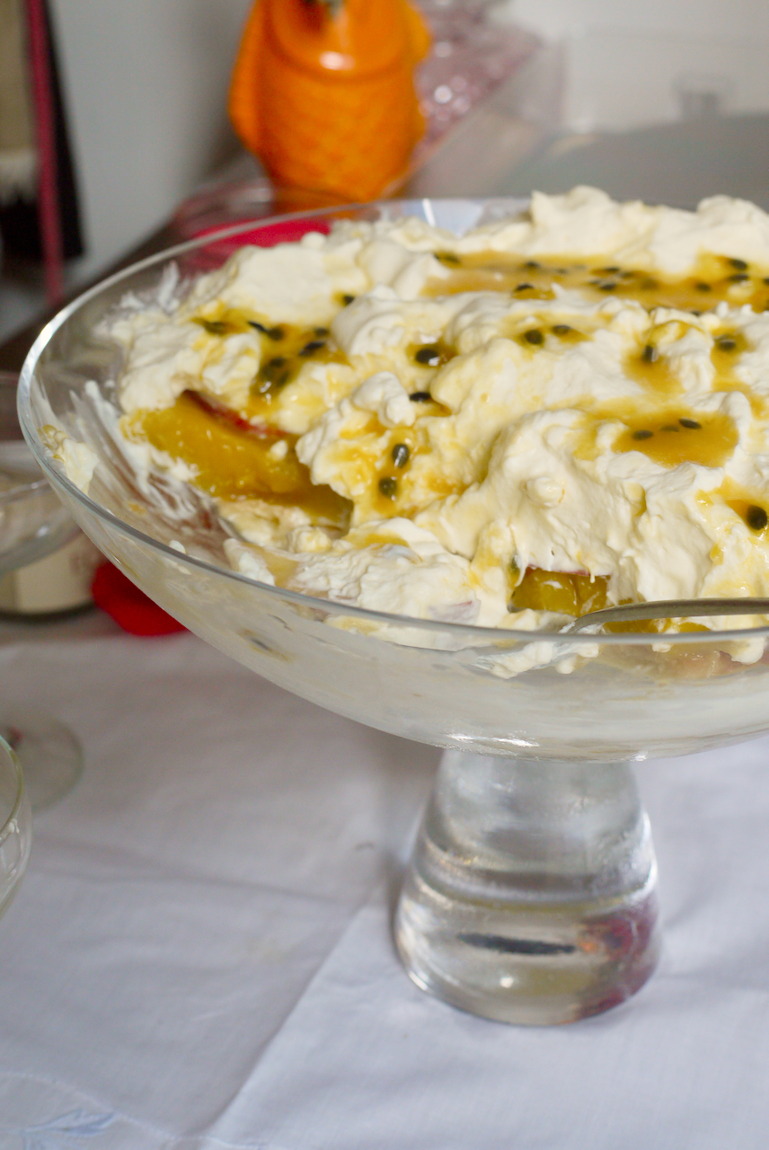 a large bowl of trifle with a spoon in it