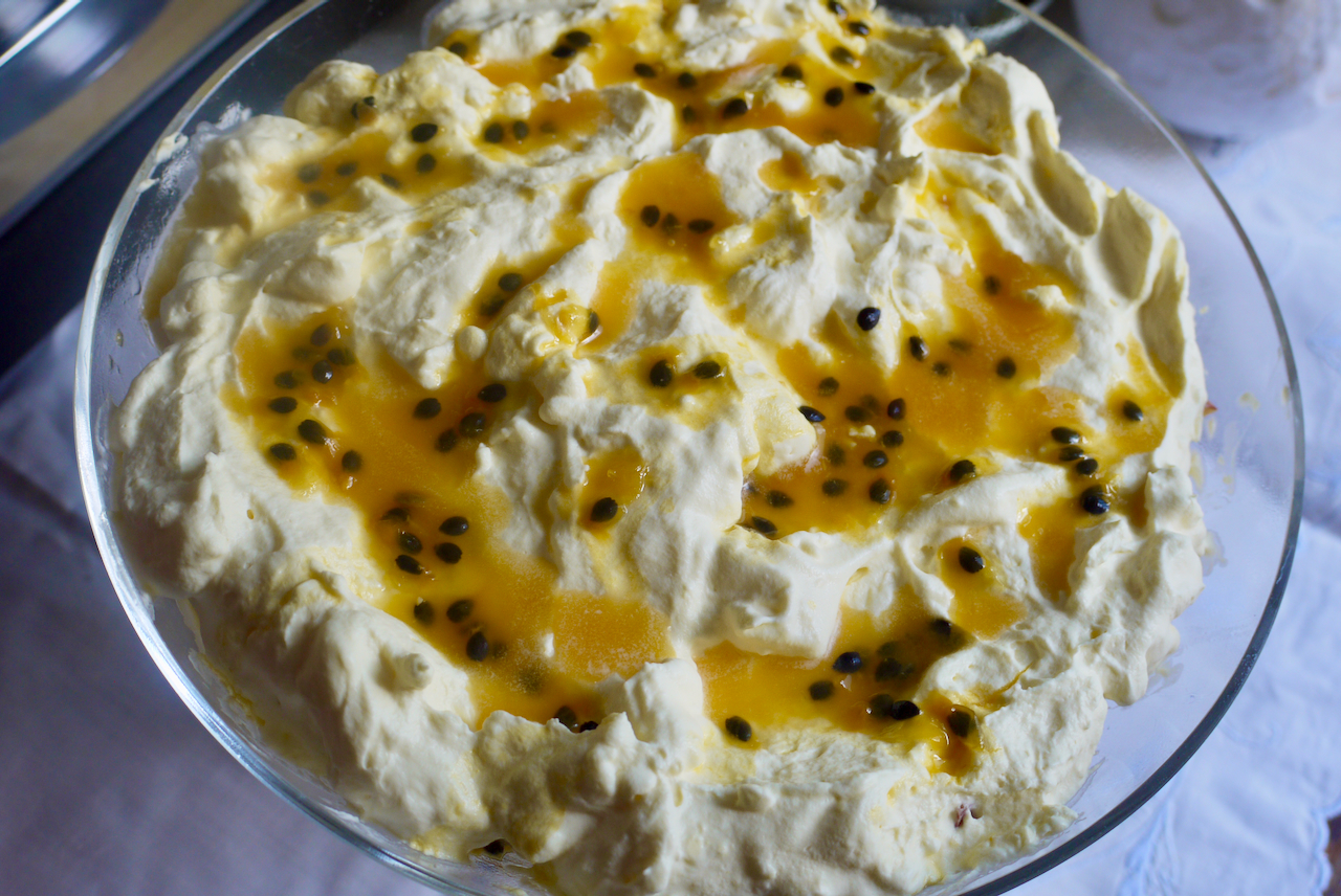close up of passionfruit on whipped cream