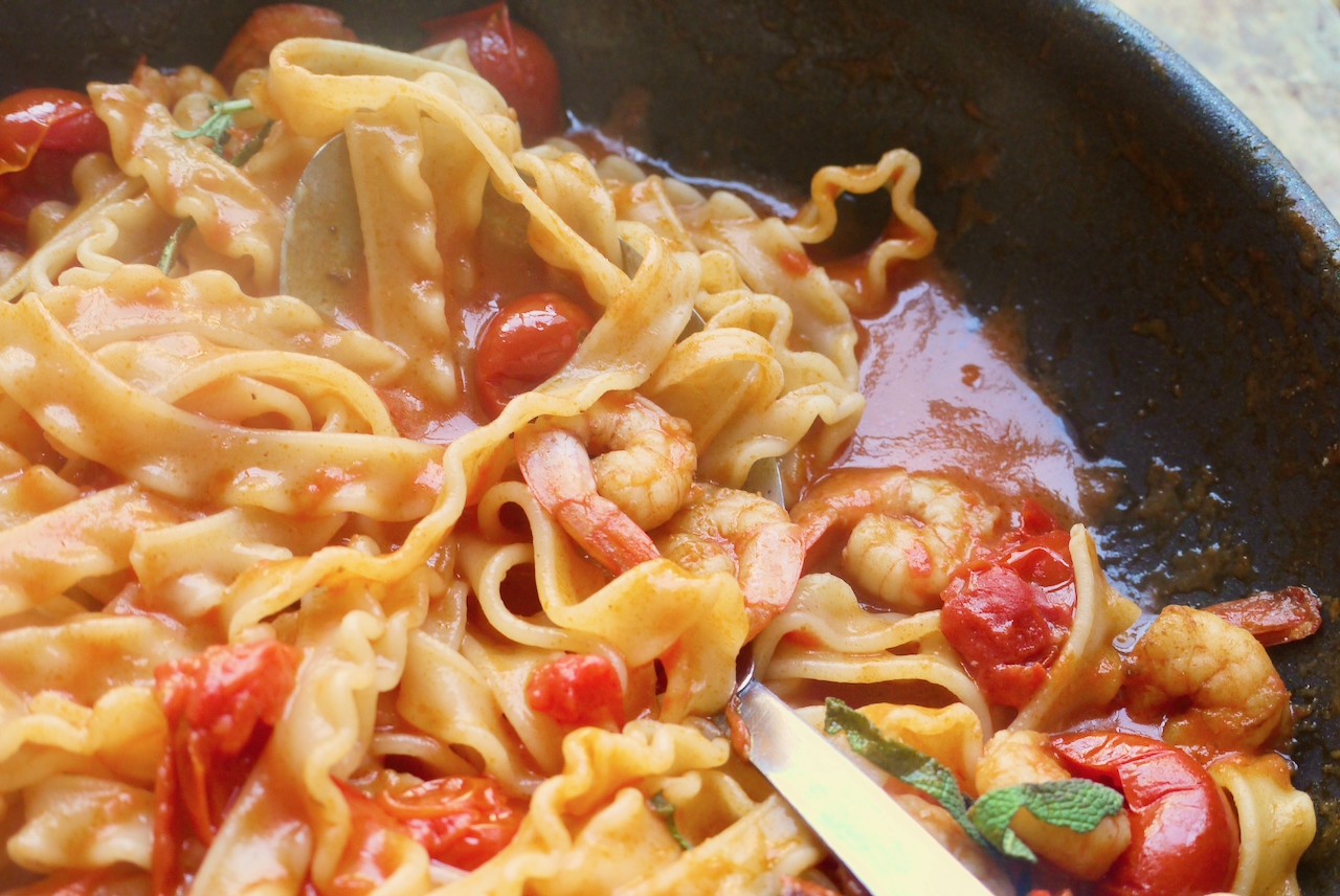 A panful of pasta with a serving spoon in it