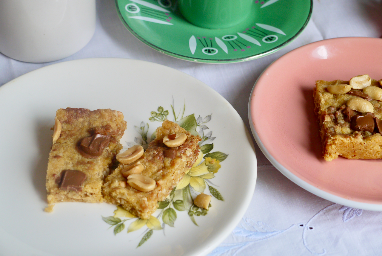 Slices of peanut butter chocolate chunk squares on small plates