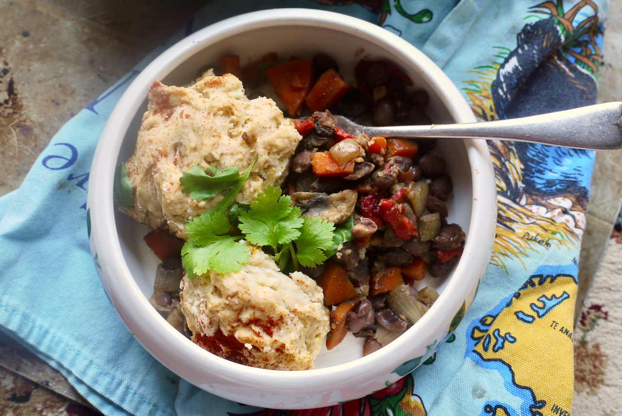 A bowl of black bean cobbler on a blue tea towel