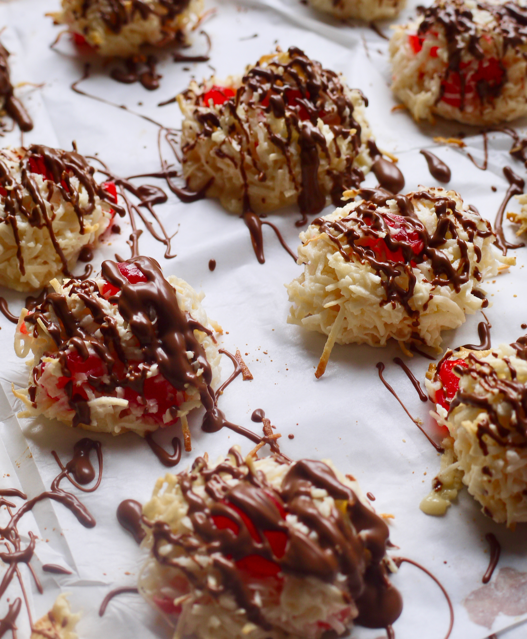 a portrait shot of cherry macaroons drizzled with chocolate