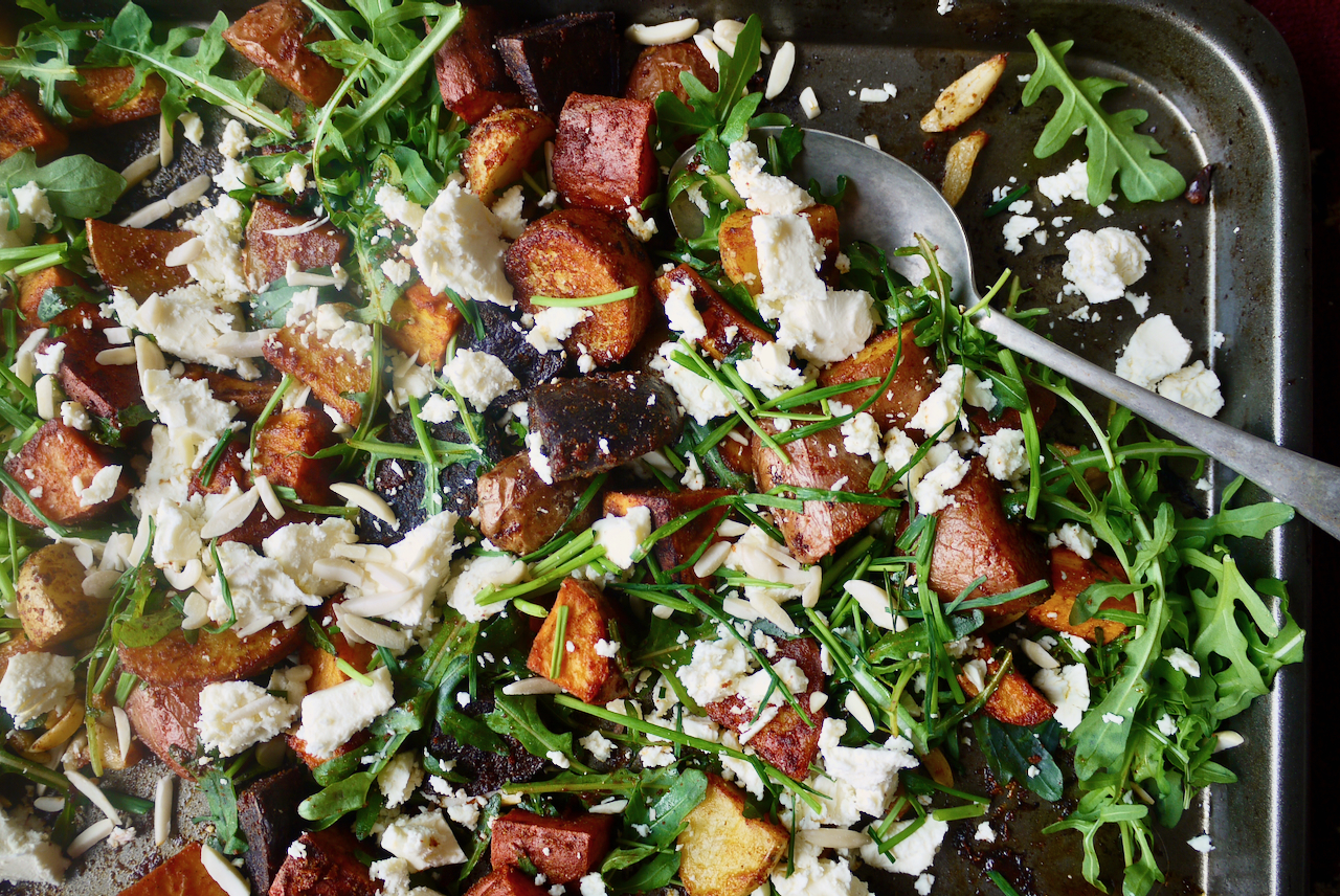 A serving spoon in a dish of roasted veges