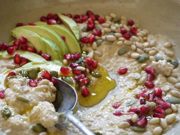 Hummus with pomegranate seeds and pine nuts.