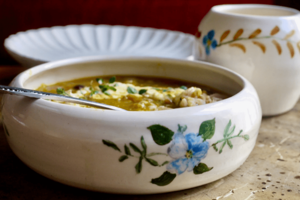 Soup in a white bowl with painted blue flowers. This image links to a web page with this recipe.