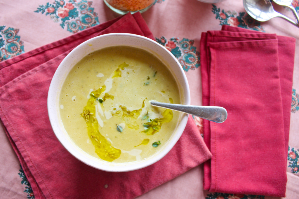 A pink bowl of soup on a red napkin resting on a pink floral tablecloth. This image links to a web page with this recipe.