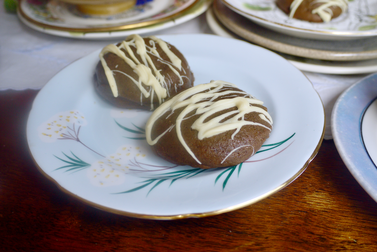 Two molasses cookies on a light blue plate