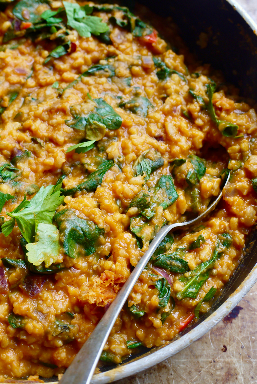 a serving spoon in a pan of sha'aktoura