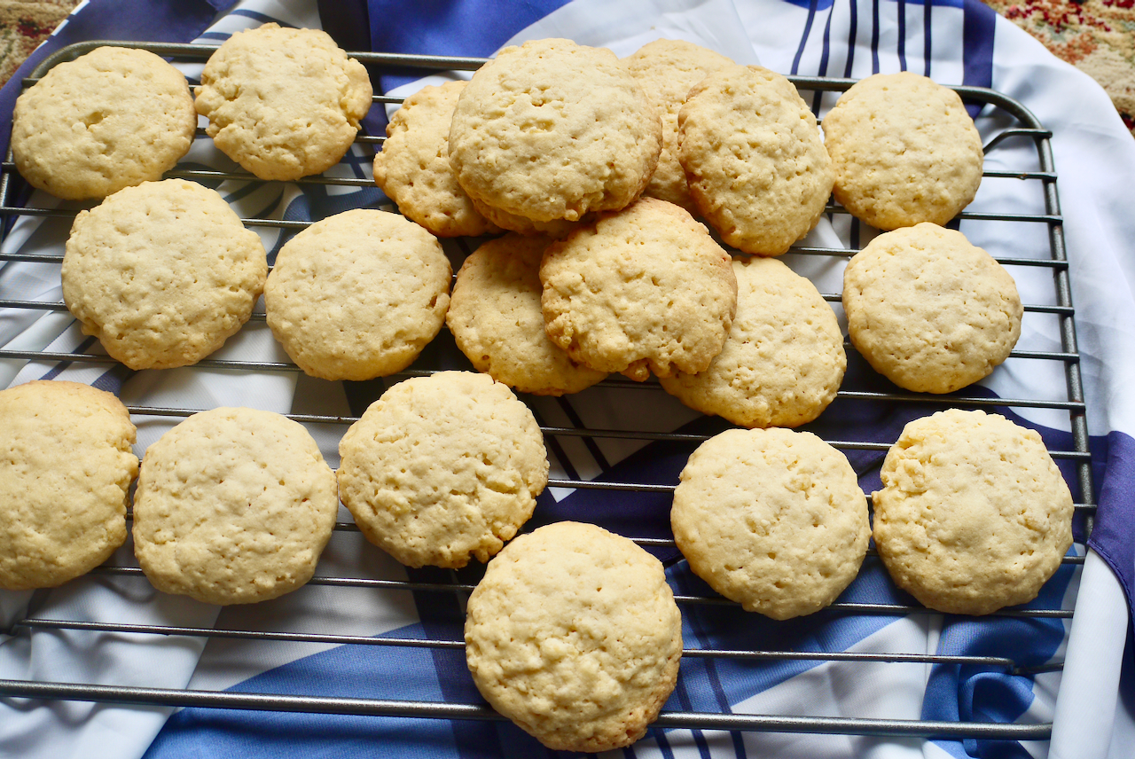 rice cookies on a cooling rack on top of a blue and white piece of fabric