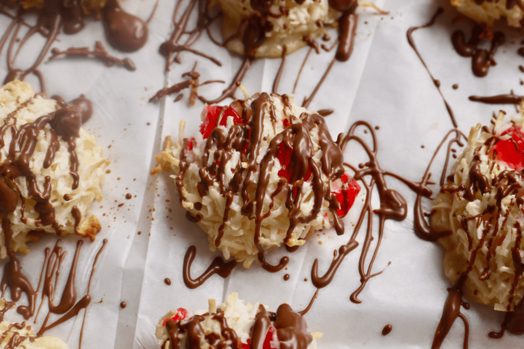 A chocolate-drizzled cherry macaroon on a tray. This image links to the macaroon recipe online.