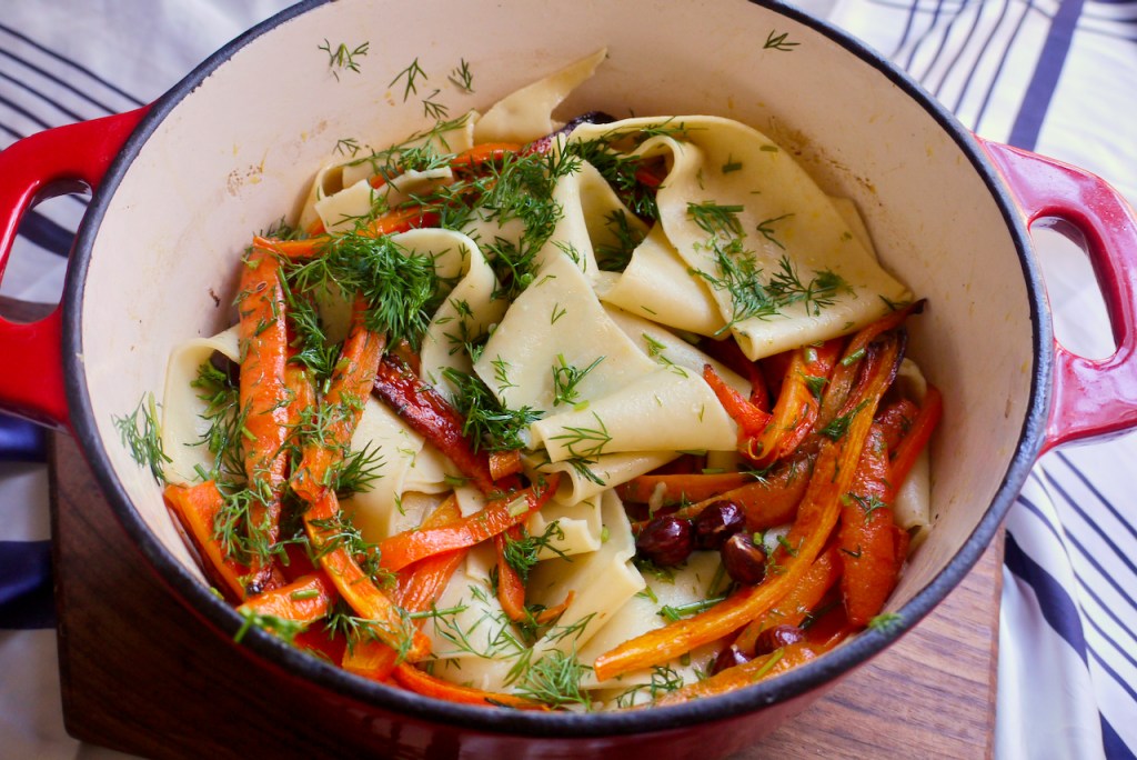 A red saucepan of pappardelle with roasted carrots