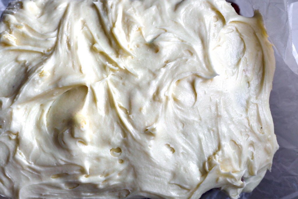 Close up of cream cheese icing on a loaf cake