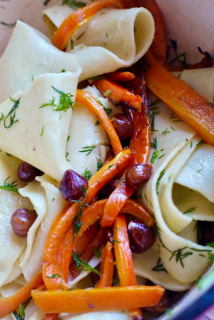Close-up of pappardelle, carrots, hazelnuts and dill